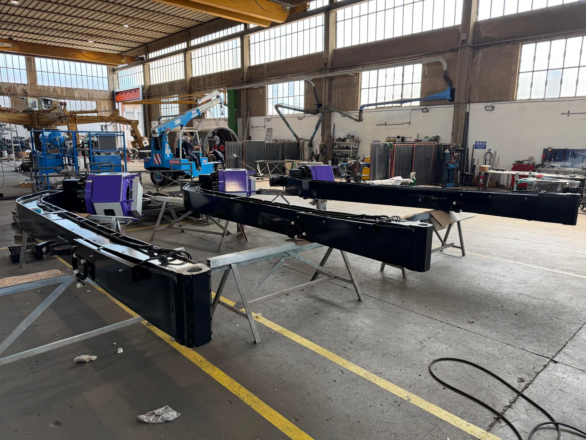 Painted structural components of an amusement ride during assembly